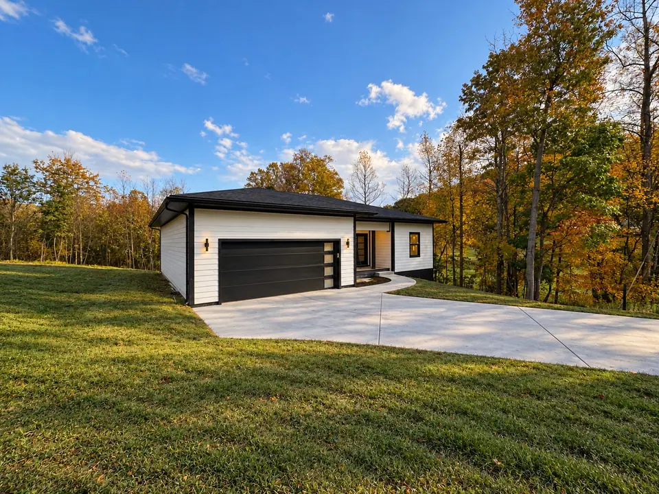 202 King Drive seen across the front lawn, with the garage and concrete driveway
