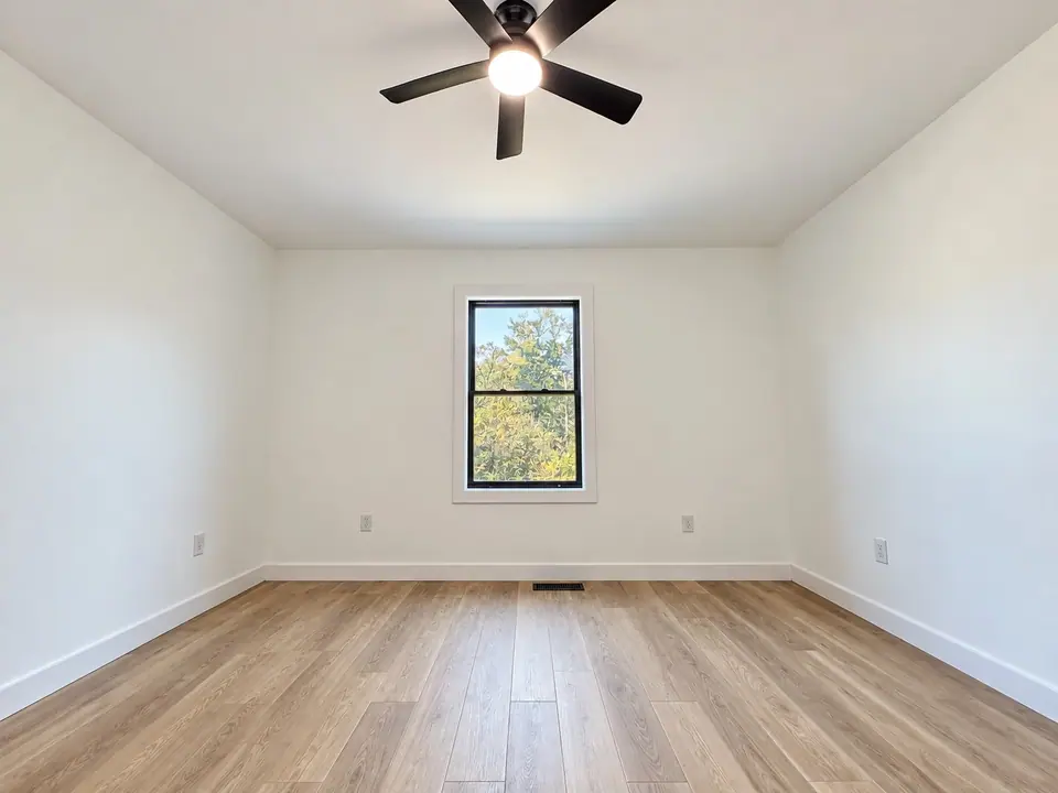 Bedroom with ceiling fan and window
