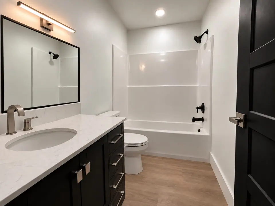 Hall bath with vanity, mirror and tub with shower